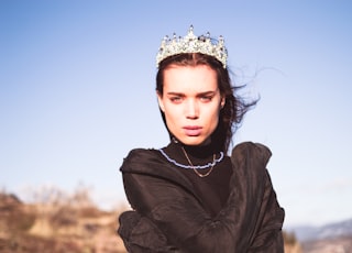 woman in black jacket wearing white flower crown