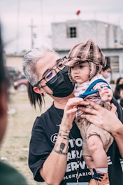 man in black crew neck t-shirt wearing black framed sunglasses
