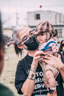 man in black crew neck t-shirt wearing black framed sunglasses