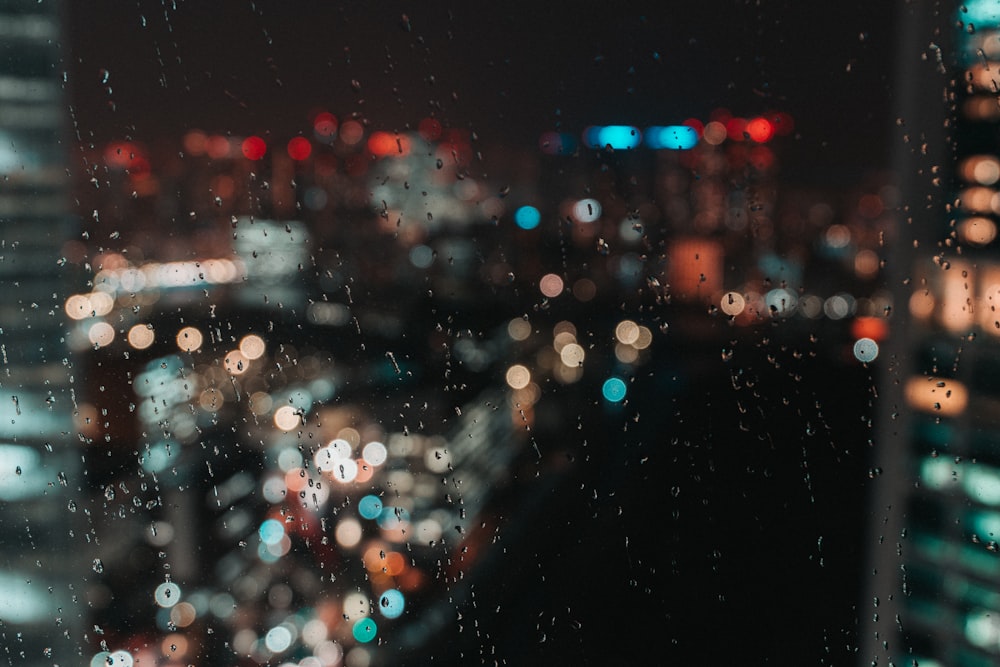 water droplets on glass window during night time