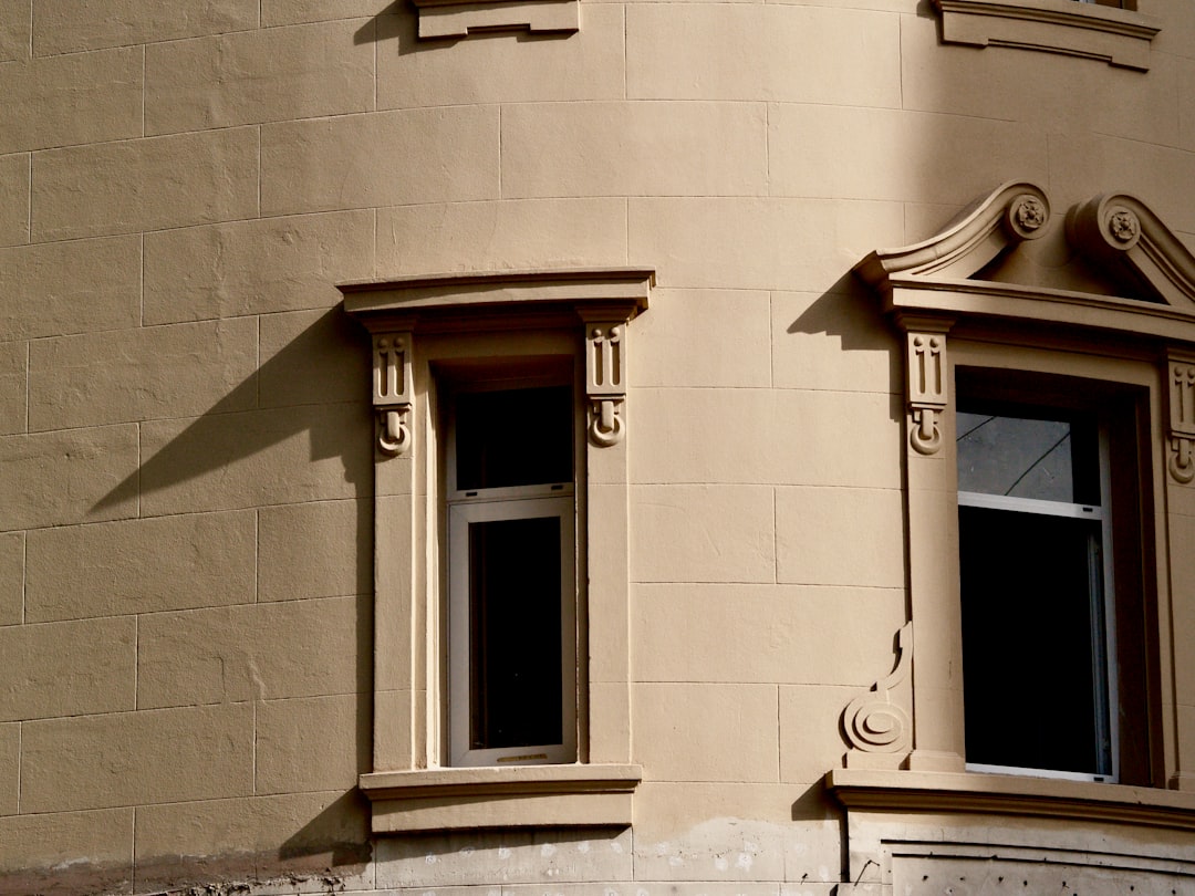 brown wooden window frame on white concrete wall