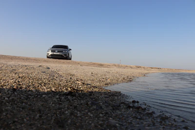 A clean, modern rental car parked by the seaside in Varna under a bright sky.