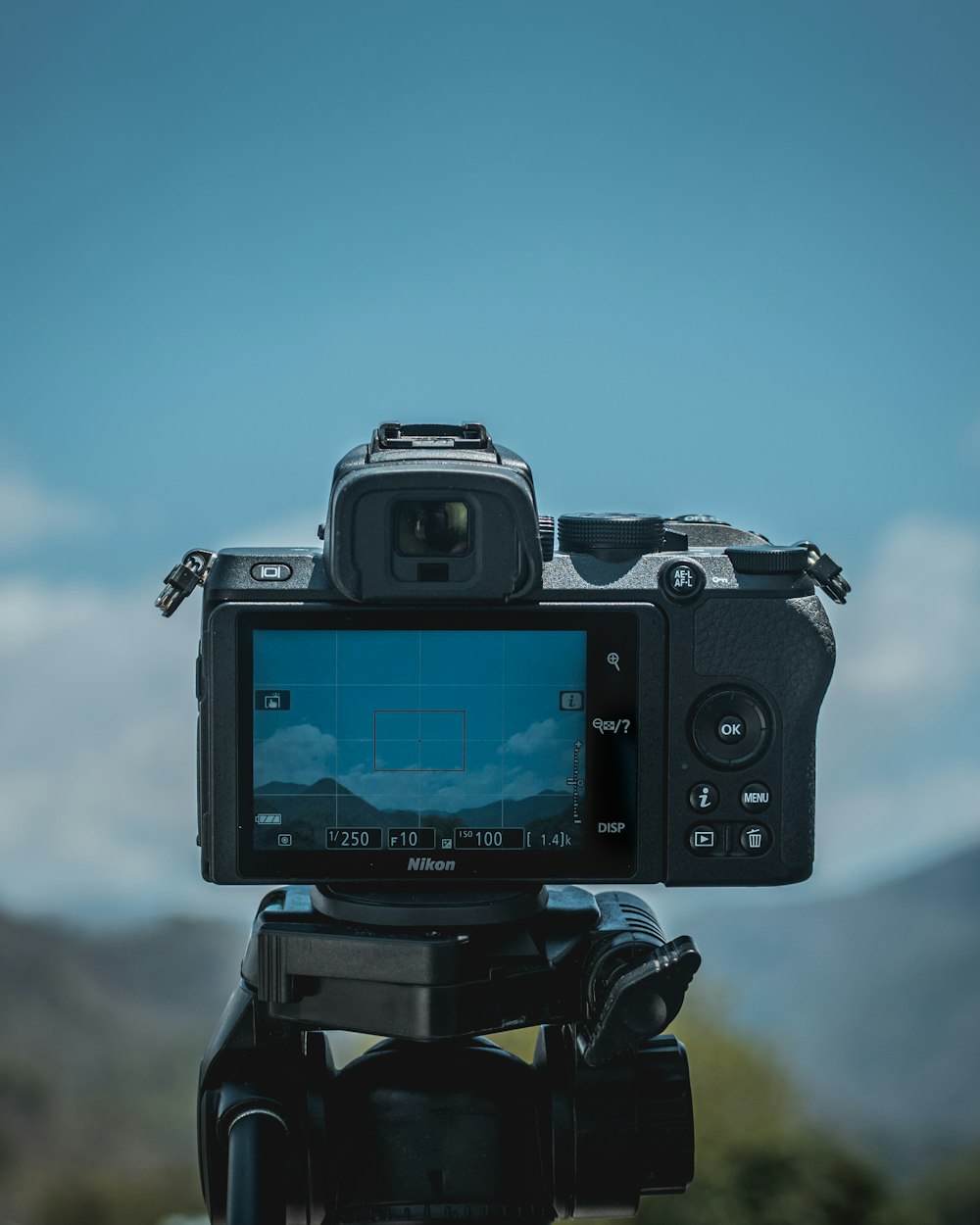 black dslr camera on tripod