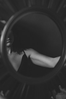 grayscale photo of woman in black brassiere