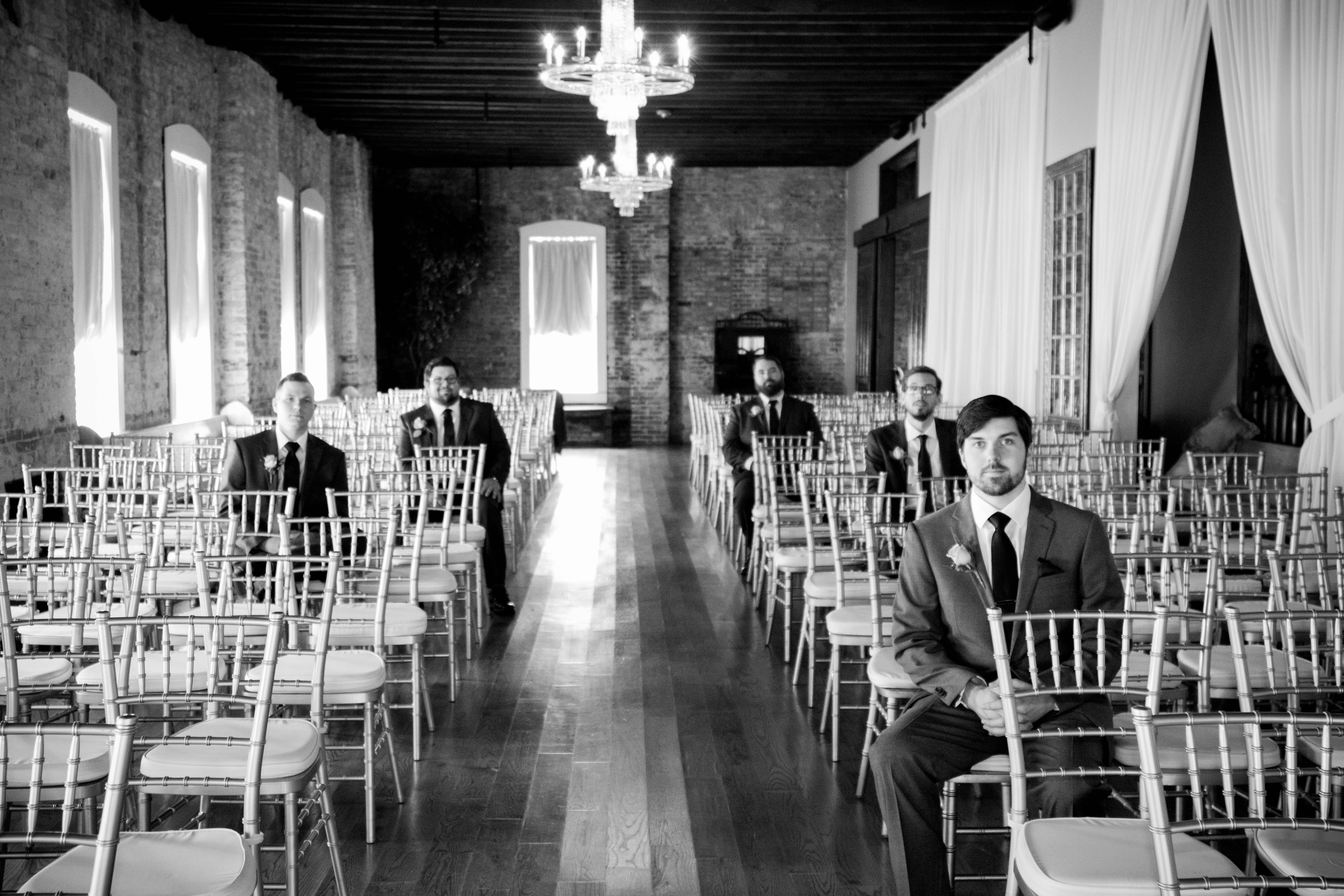 grayscale photo of man and woman sitting on chair