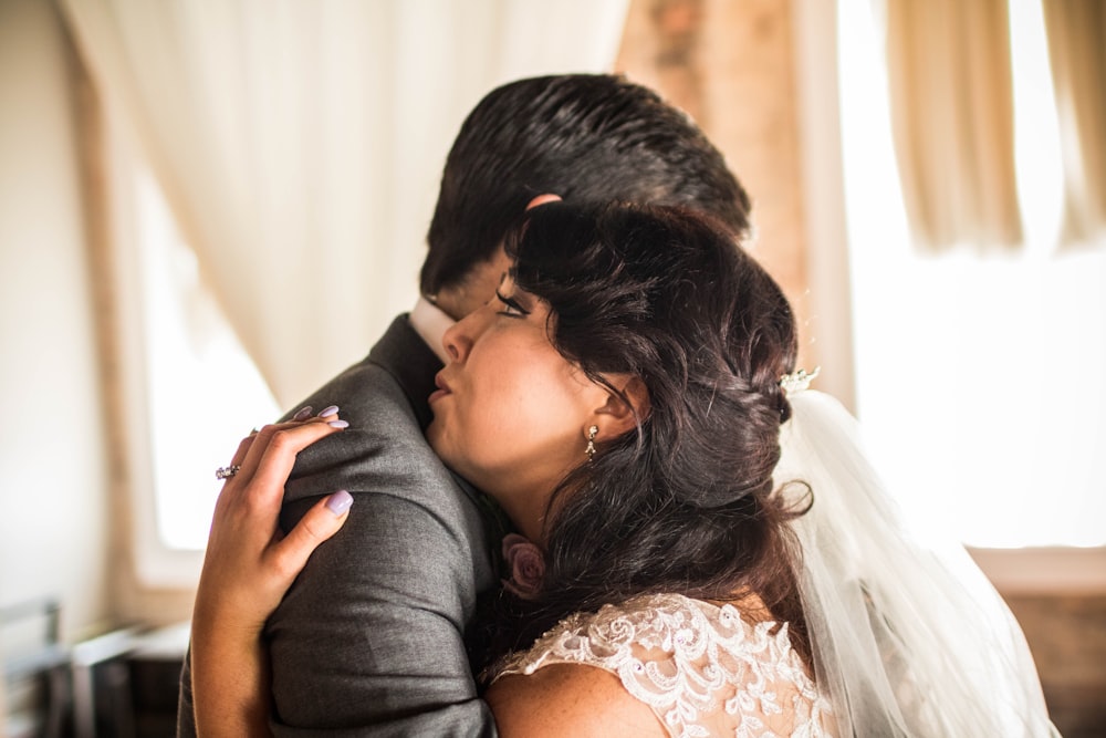 man kissing womans forehead