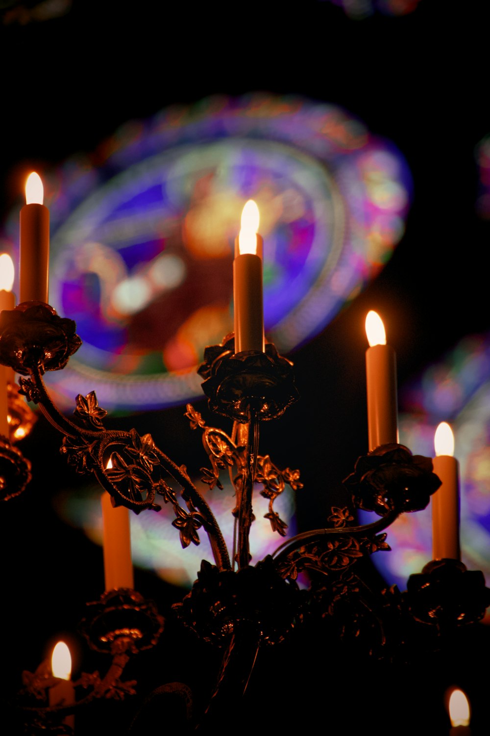 lighted candles on black metal candle holder