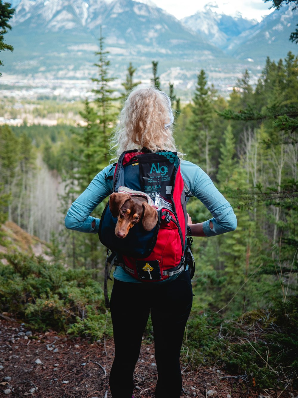 woman in blue jacket carrying a baby in black jacket