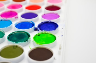 white green blue and pink round plastic containers