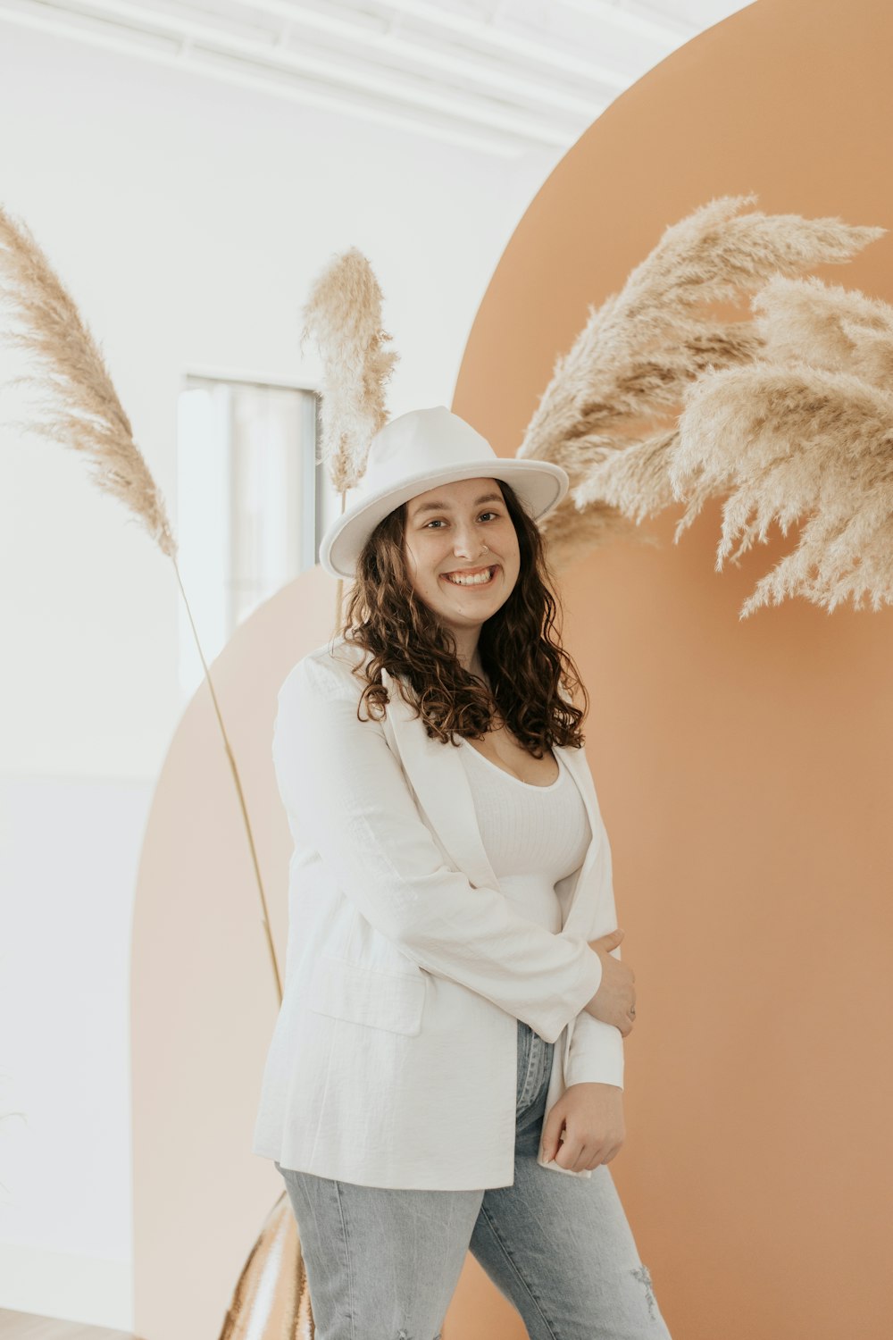 woman in white long sleeve shirt and white hat