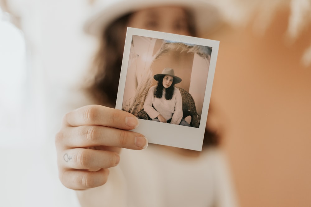 person holding picture of 2 women