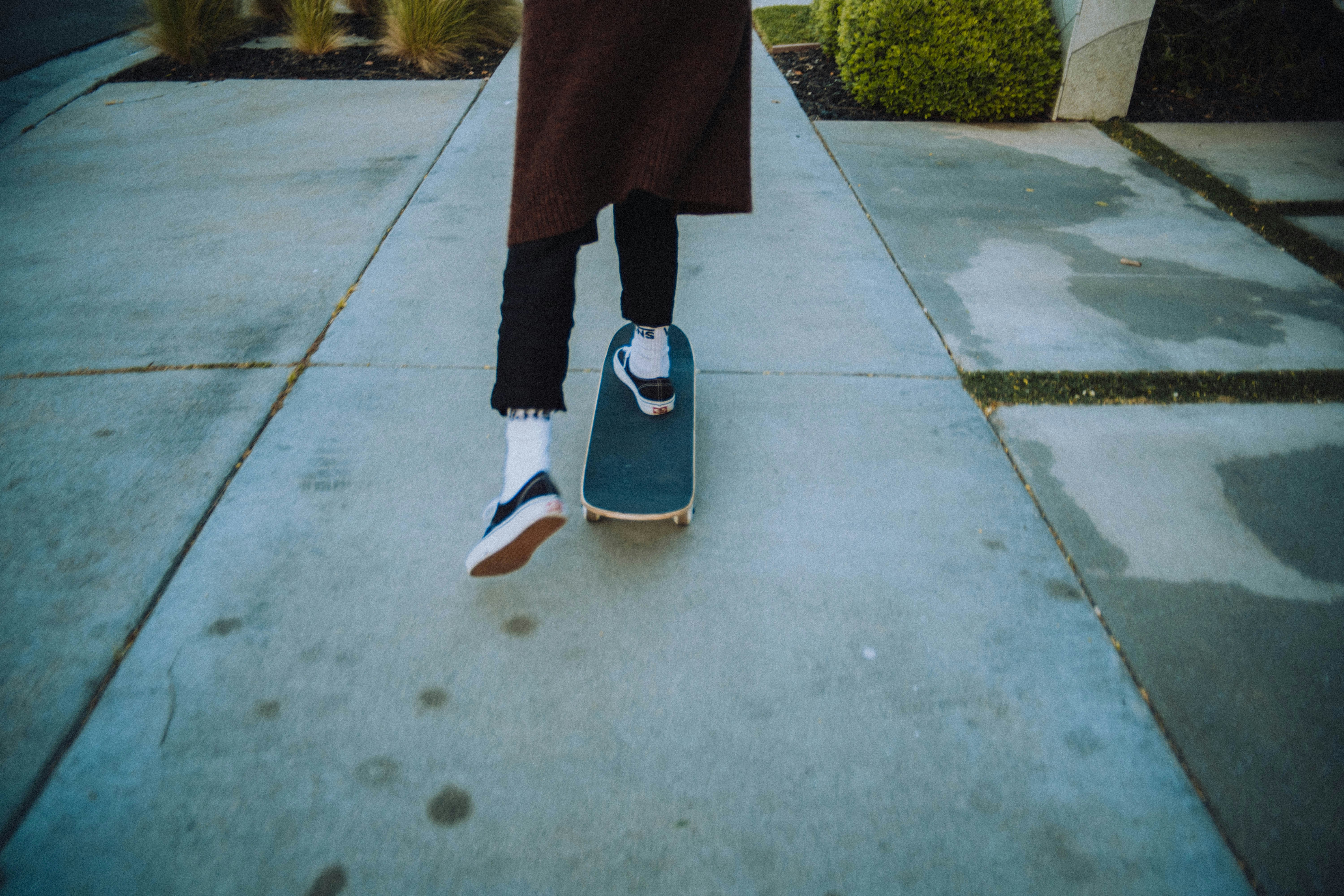 person in red pants and blue and white sneakers