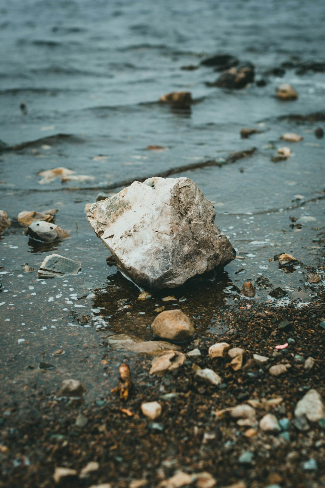 white and gray stone on gray sand