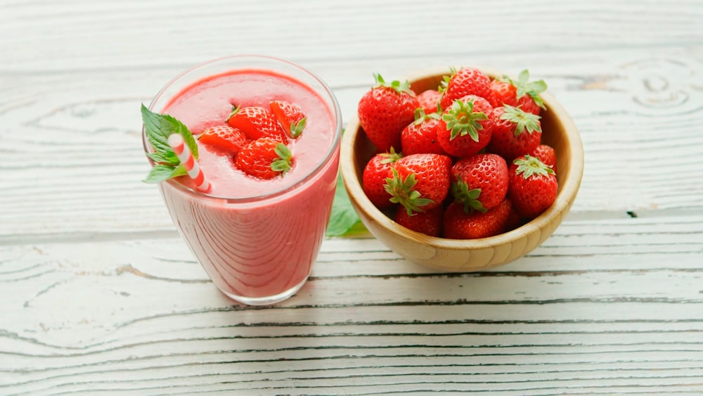 red strawberries in pink plastic cup