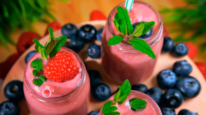 Berry smoothies in glasses with fresh fruit