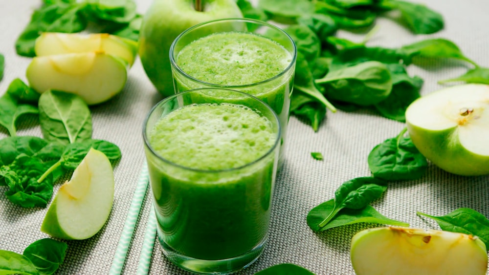 green liquid in clear drinking glass