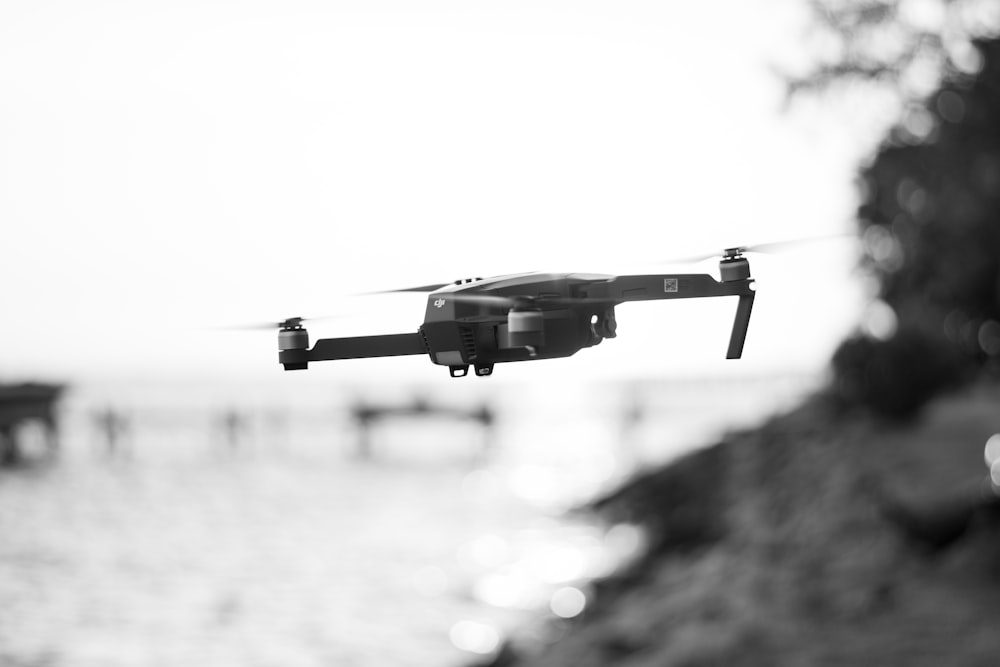 grayscale photo of a flying drone