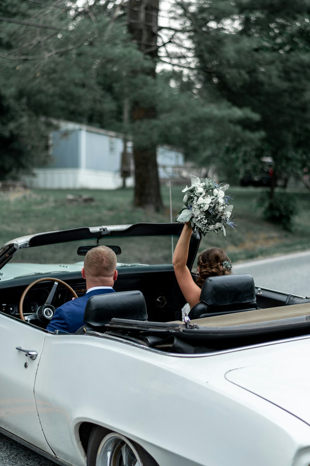 man and woman riding on convertible car during daytime