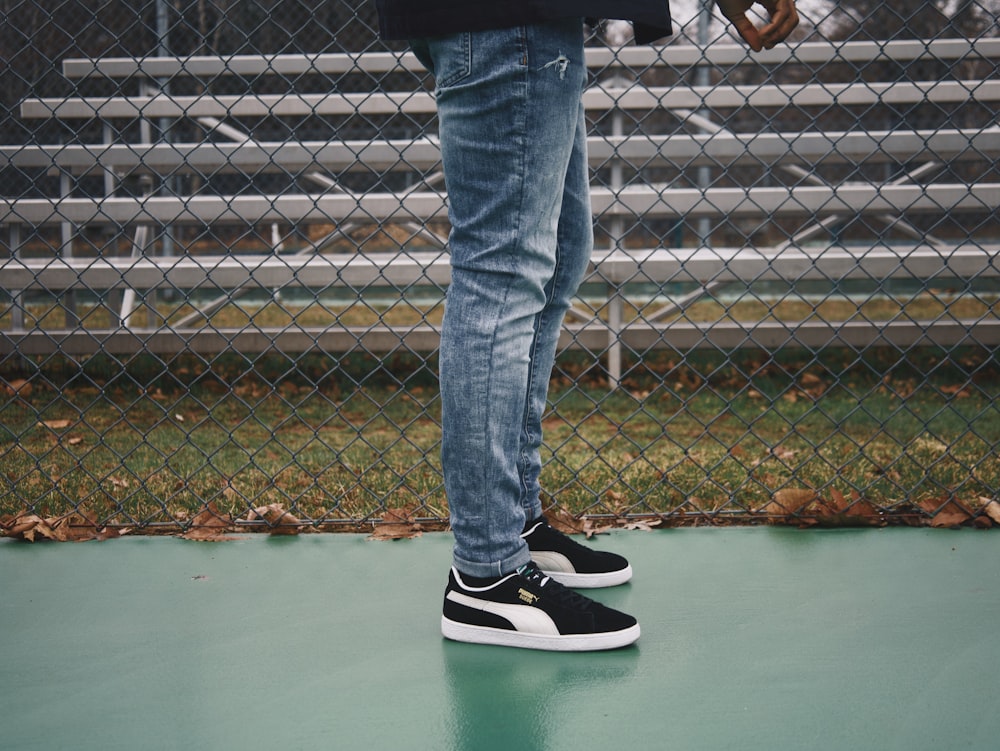 Person in blue denim jeans and black and white adidas sneakers photo – Free  Pants Image on Unsplash