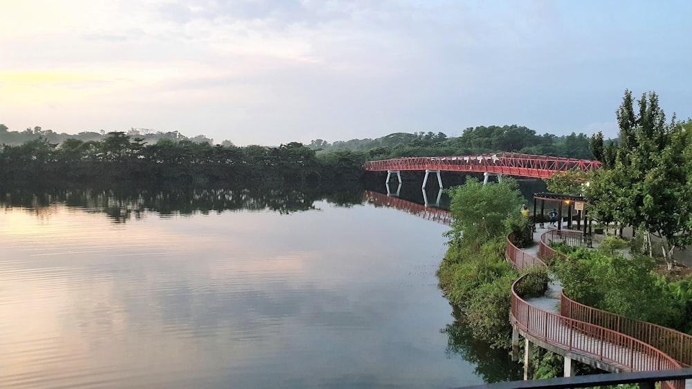 red bridge over river during daytime