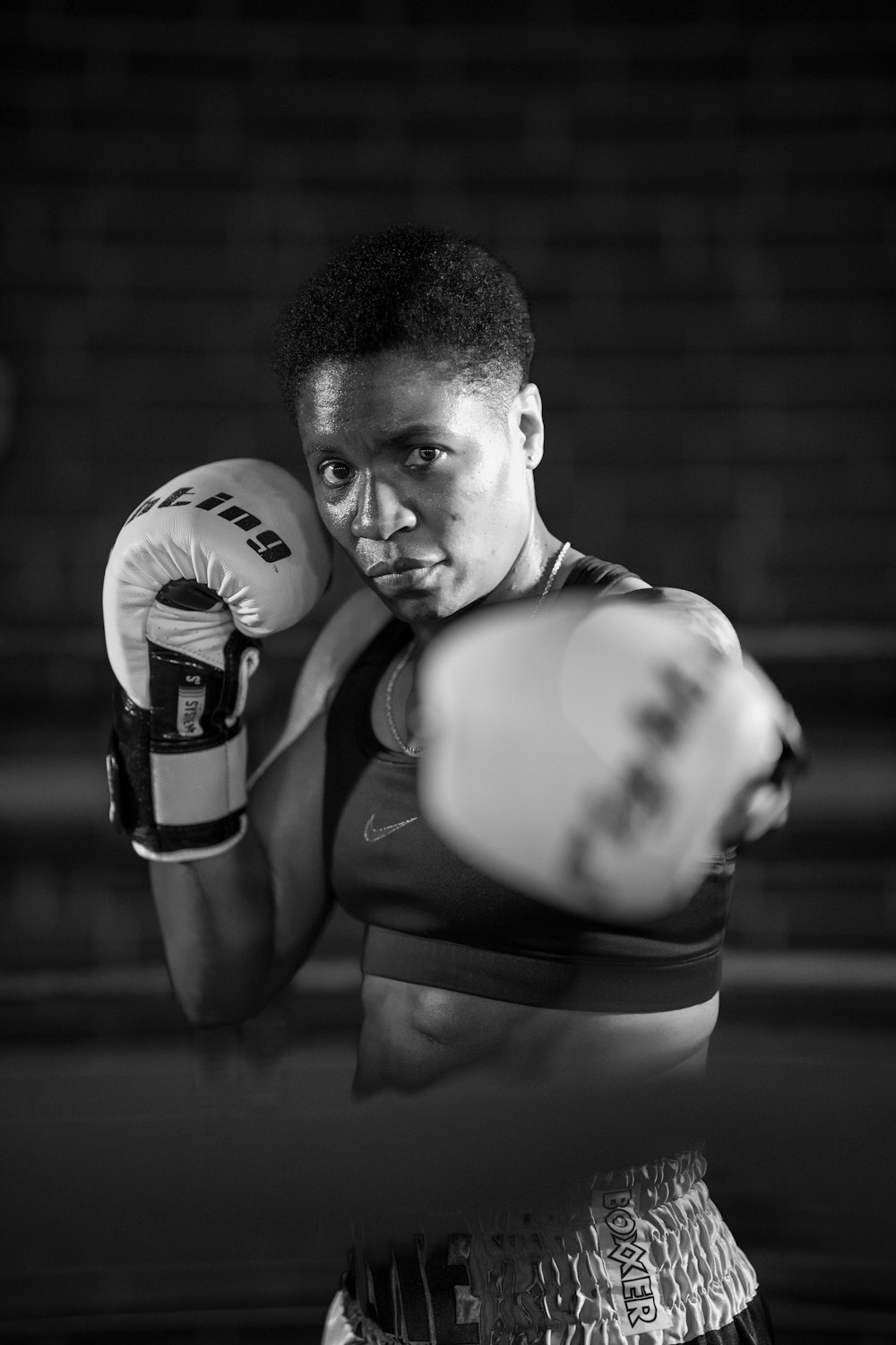 grayscale photo of man in boxing gloves