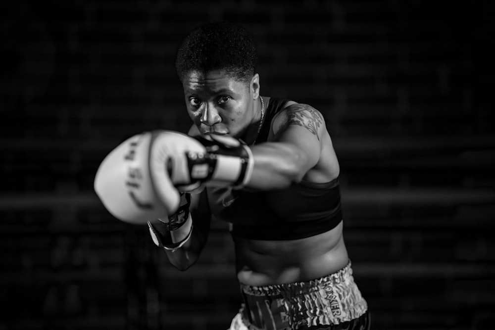 grayscale photo of woman in boxing gloves
