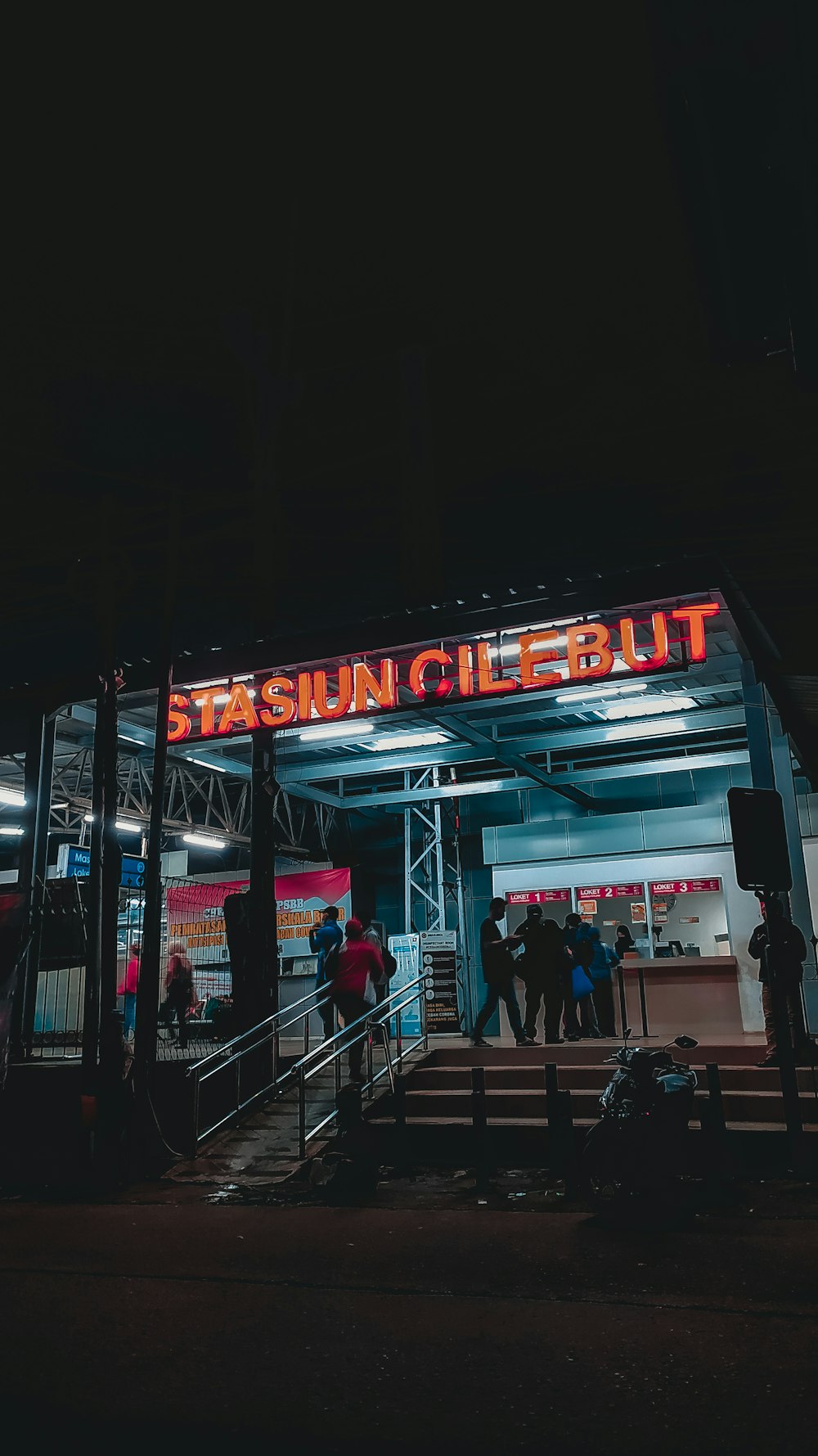 people walking on sidewalk during nighttime