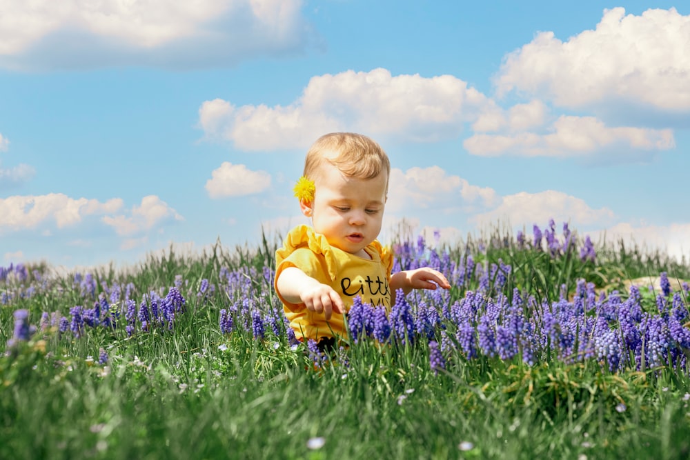 girl in yellow shirt on green grass field during daytime