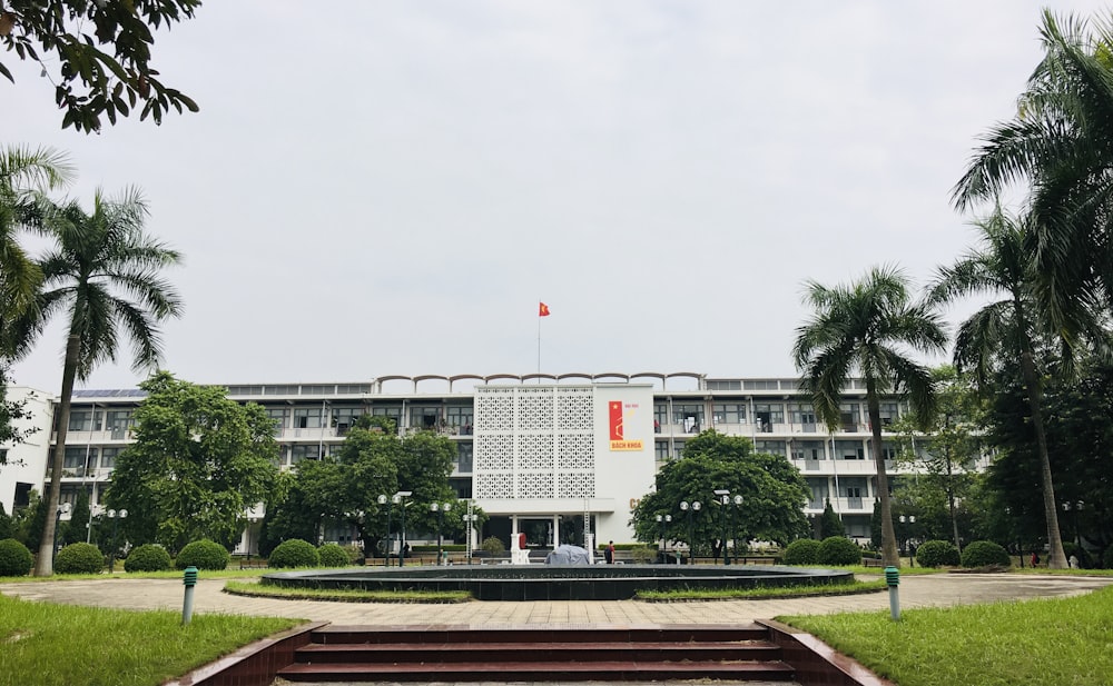 white concrete building near green trees during daytime