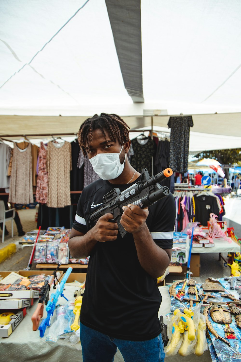 woman in black shirt holding black rifle