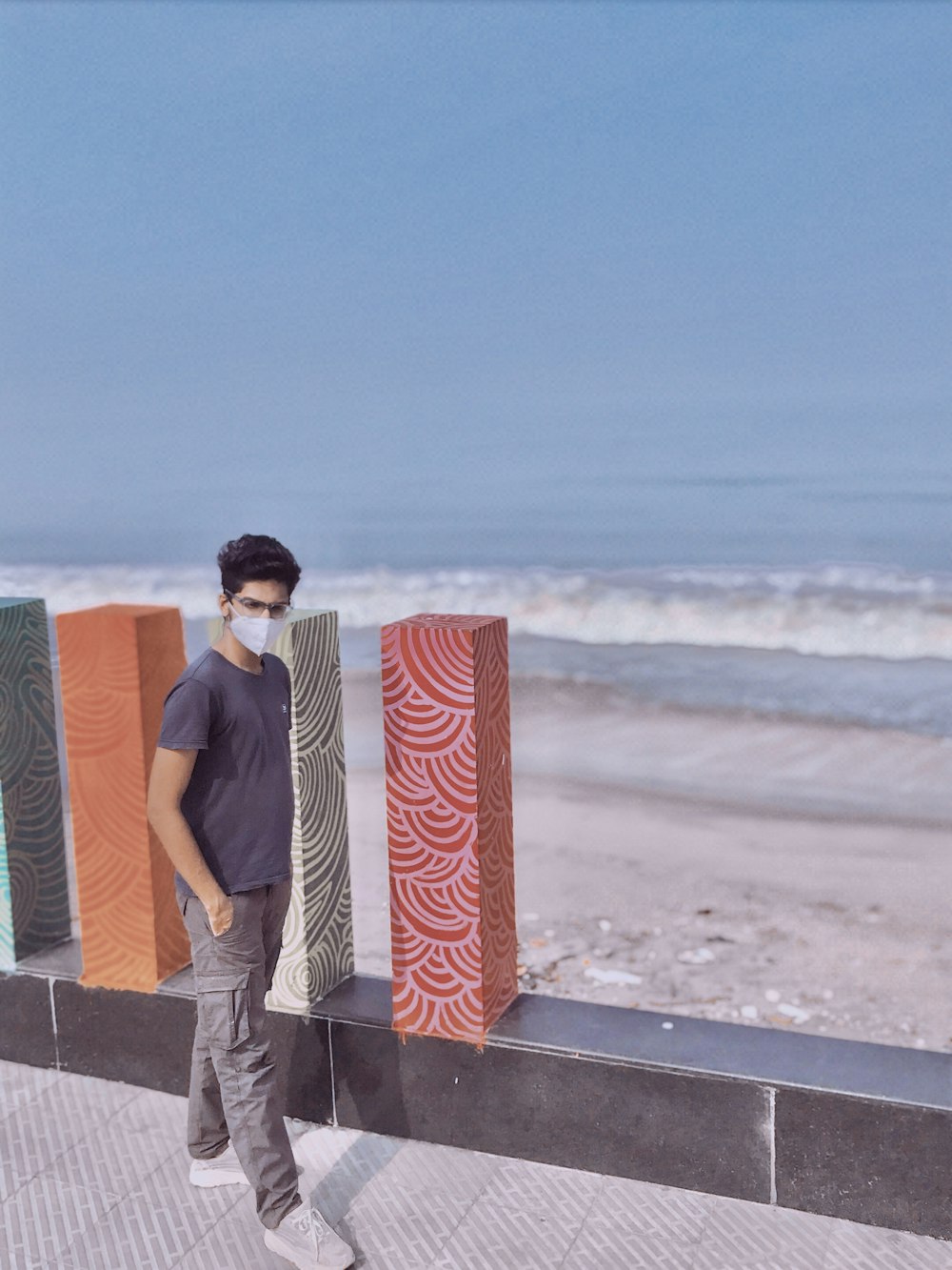 man and woman holding red and white gift box standing on beach during daytime