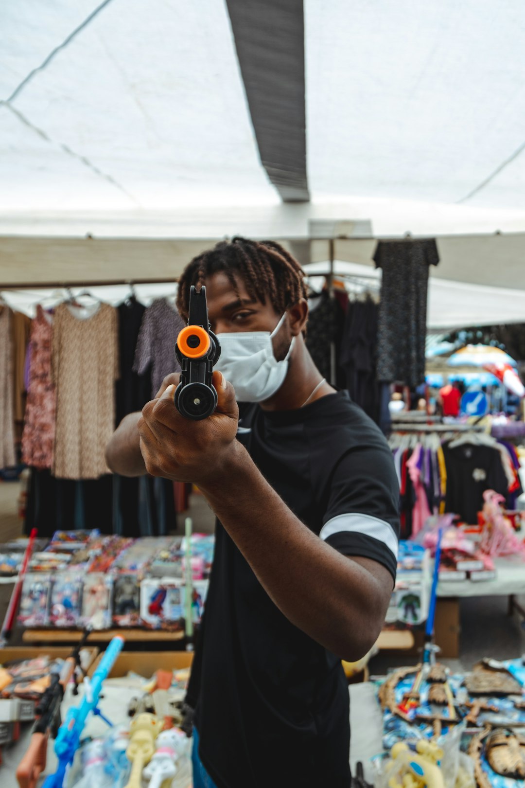 man in black t-shirt holding black camera