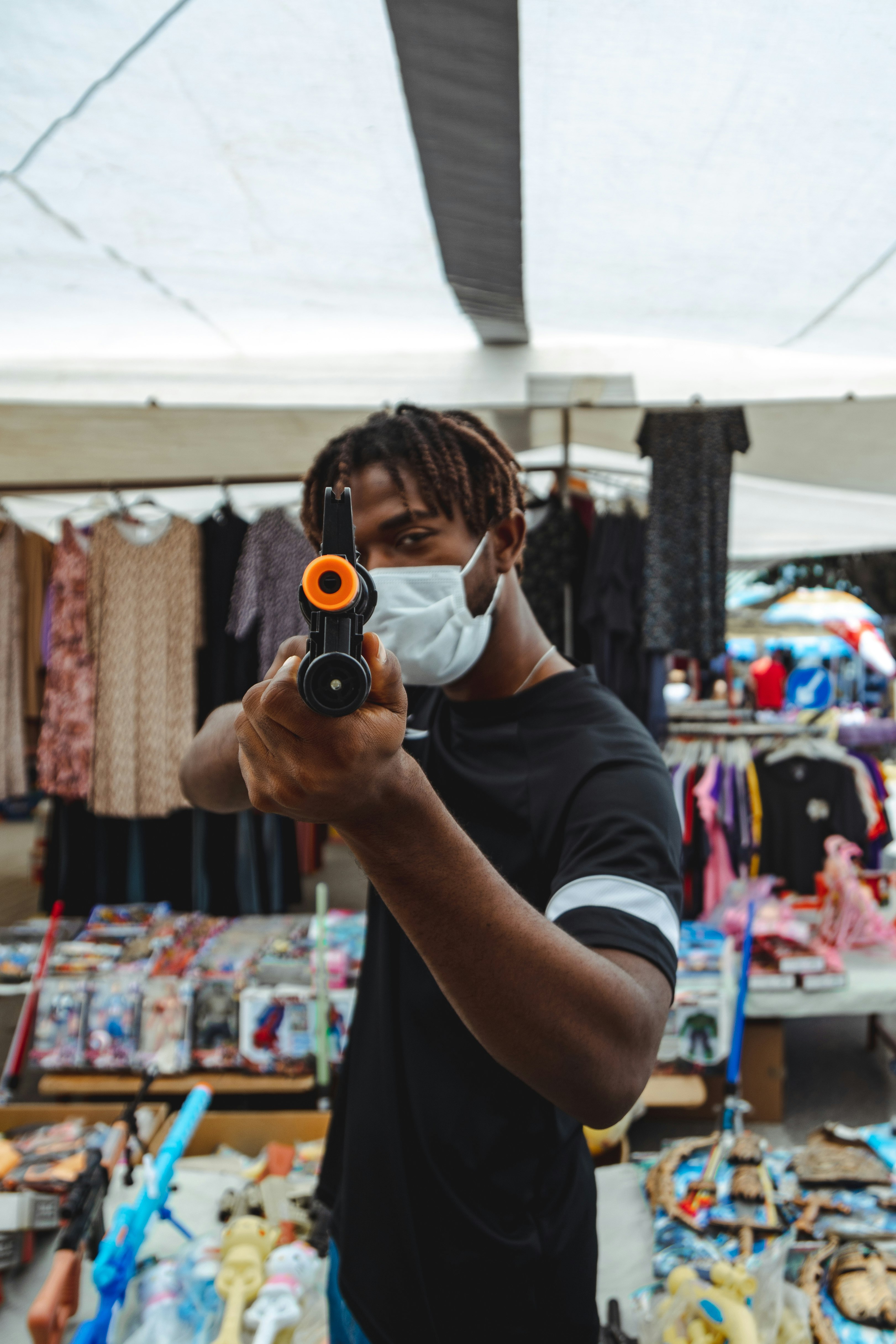 man in black t-shirt holding black camera