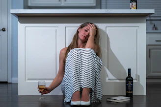 woman in black and white stripe tank top sitting on chair
