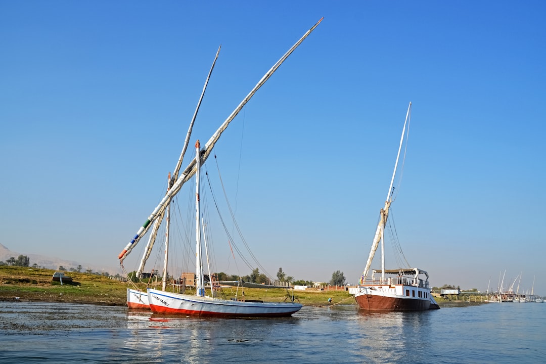 white and brown sail boat on body of water during daytime
