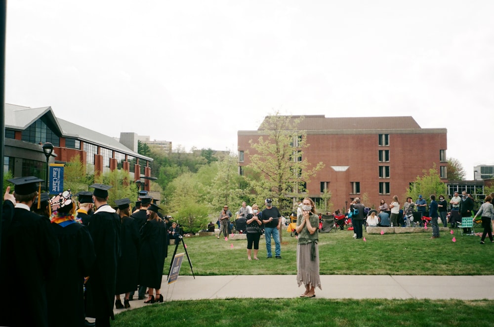 people standing on green grass field during daytime