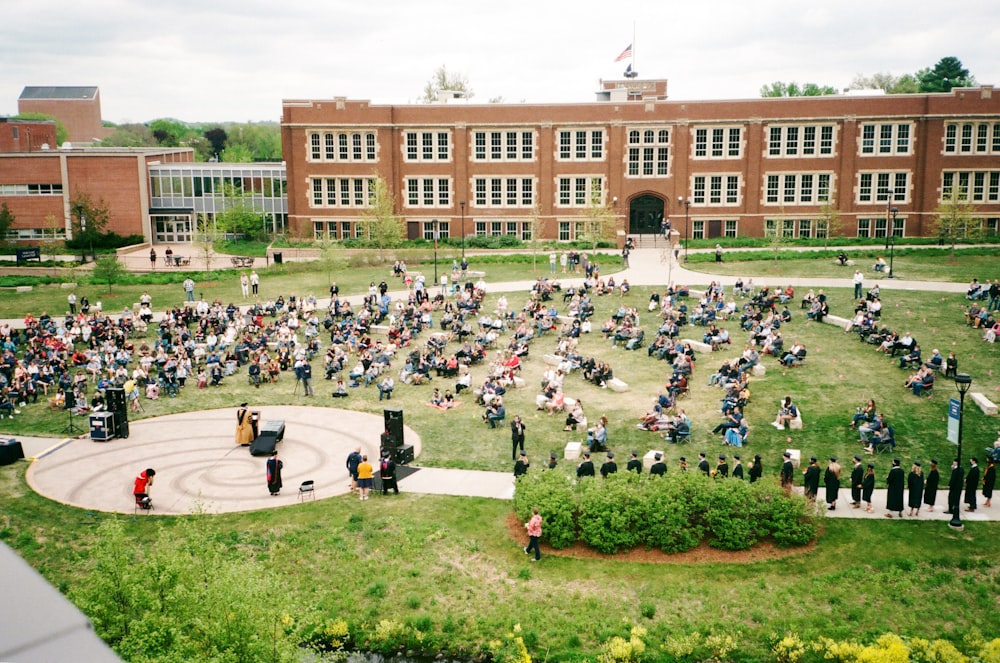 people in front of brown building during daytime
