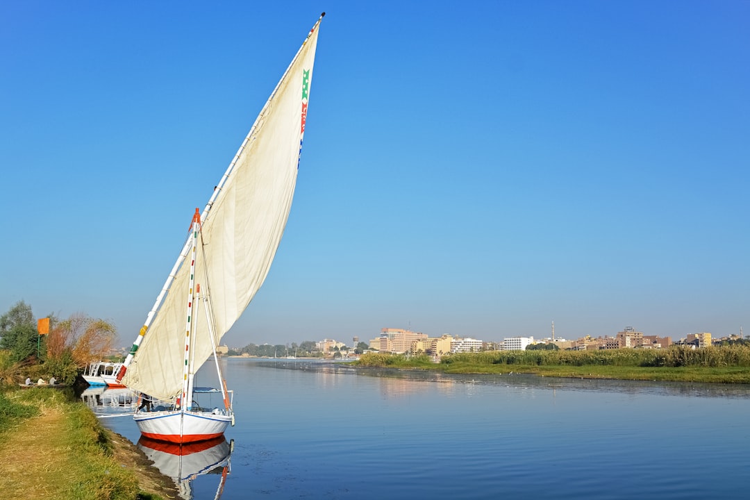 white sail boat on water during daytime