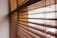 Close-up of a bamboo blind neatly installed on a balcony with sunlight filtering through.