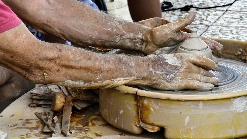 person in blue shorts holding brown meat