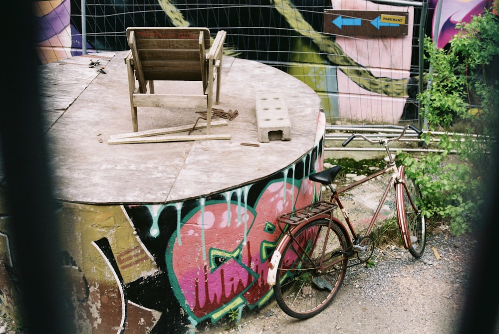 blue bicycle beside brown wooden table