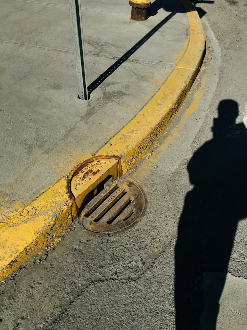 person in black pants standing on gray concrete road