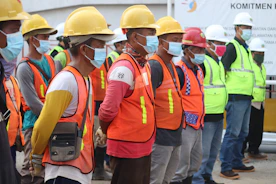 group of people wearing orange and yellow safety vest