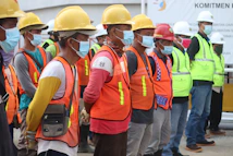 group of people wearing orange and yellow safety vest