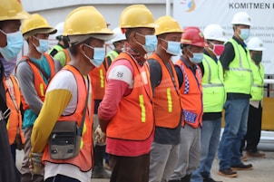 group of people wearing orange and yellow safety vest