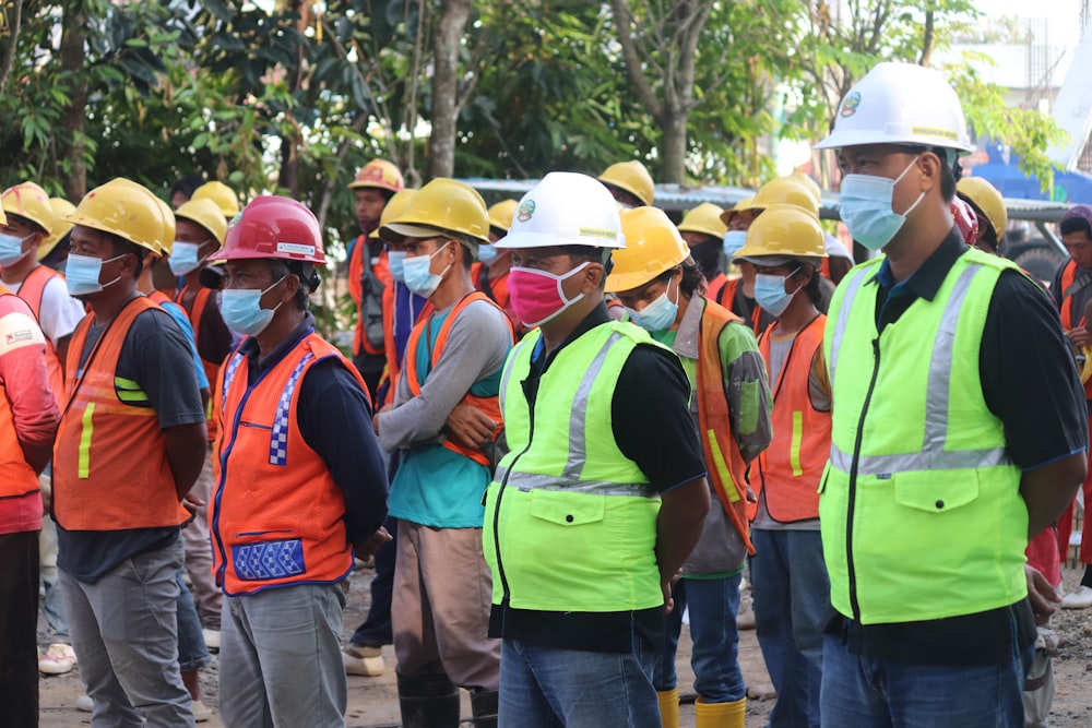 group of people wearing orange hard hat and backpacks