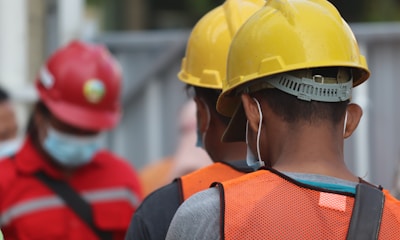 man in orange helmet and black jacket