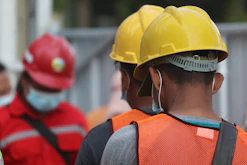man in orange helmet and black jacket