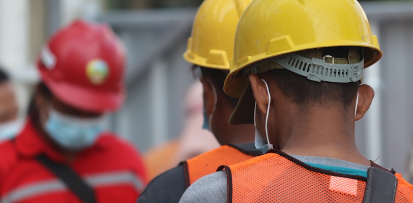 man in orange helmet and black jacket