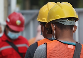 man in orange helmet and black jacket